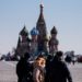 A woman wearing a protective face mask due to fears of the coronavirus disease (COVID-19) walks on Red Square in front of St.Basil's Cathedral in downtown Moscow on March 17, 2020. (Photo by Dimitar DILKOFF / AFP)