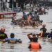 Rescuers pull a rubber boat carrying residents through a flooded street after Typhoon Vamco hit in Marikina City, suburban Manila on November 12, 2020. (Photo by Ted ALJIBE / AFP)