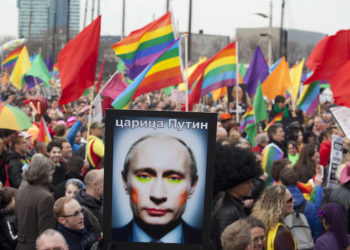 A demonstrator holds up a picture depicting Russian President Vladimir Putin with make-up during a protest by the gay community in Amsterdam in this April 8, 2013 file photo. Putin and his wife, Lyudmila, said on state television on Thursday that they had separated and their marriage was over after 30 years. REUTERS/Cris Toala Olivares/Files (NETHERLANDS - Tags: CIVIL UNREST SOCIETY POLITICS)