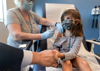 Bridgette Melo, 5, holds onto the hand of her dad Jim Melo as she gets the first of two Pfizer COVID vaccinations on September 28, 2021 during a clinical trial for children at Duke Health.
Shawn Rocco/Duke Health
Photos provided by Duke Health. Permission for CNN to use across all platforms and distribute to affils.