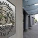 Pedestrians walk past the International Monetary Fund headquarters' complex in Washington Sunday, May 2, 2010. A senior International Monetary Fund official says the IMF's executive board is meeting in Washington to consider how much aid to grant Athens under a massive rescue loan package. (AP Photo/Cliff Owen)