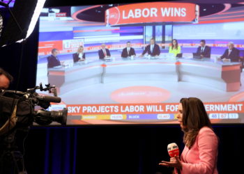 A TV presenter does a piece to camera with Sky News telecast up on the screen which projects that Anthony Albanese, leader of Australia's Labor Party, is going to be the next prime minister at Scott Morrison's election day event in Sydney, Australia May 21, 2022. REUTERS/Loren Elliott