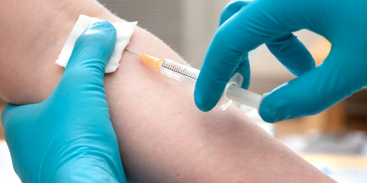 Doctor giving an injection to a patient