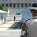 South Korean Soldier stands guard on the DMZ, North Korea is in the background