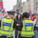 Edinburgh city police keep an eye on crowds at the Royal Mile during Edinburgh Fringe Festival.