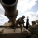 FILE PHOTO: Members of the U.S. 2nd Battalion, 7th Infantry Regiment, 1st Brigade Combat Team, 3rd Infantry Division get ammunition to the Abrams tank during an exercise at Mielno range near Drawsko-Pomorskie April 16, 2015. REUTERS/Kacper Pempel