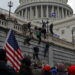 Supporters of U.S. President Donald Trump climb a wall during a protest against the certification of the 2020 presidential election results by the Congress, at the Capitol in Washington, U.S., January 6, 2021. Picture taken January 6, 2021. REUTERS/Jim Urquhart