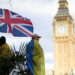 FILE PHOTO: A demonstrator holds a British flag during a protest against Russia's invasion of Ukraine, at Parliament Square in London, Britain, March 6, 2022. REUTERS/Henry Nicholls/File Photo