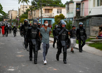 A man is arrested during a demonstration against the government of President Miguel Diaz-Canel in Arroyo Naranjo Municipality, Havana on July 12, 2021. - Cuba on Monday blamed a "policy of economic suffocation" of United States for unprecedented anti-government protests, as President Joe Biden backed calls to end "decades of repression" on the communist island. Thousands of Cubans participated in Sunday's demonstrations, chanting "Down with the dictatorship," as President Miguel Díaz-Canel urged supporters to confront the protesters. (Photo by YAMIL LAGE / AFP)